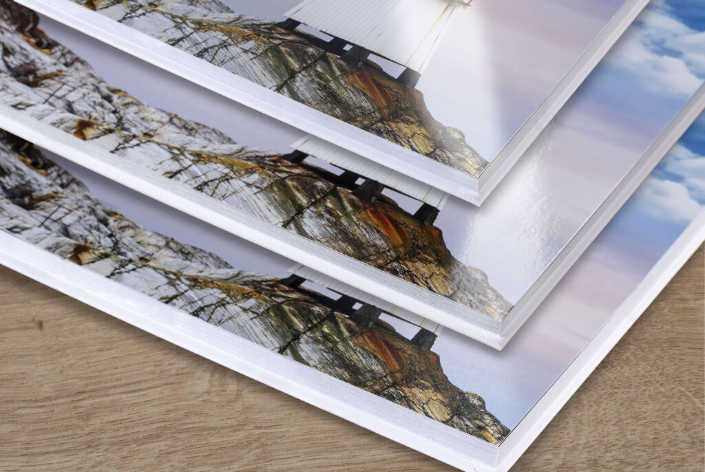 Tres álbumes de fotos apilados con hermosas imágenes de paisajes.