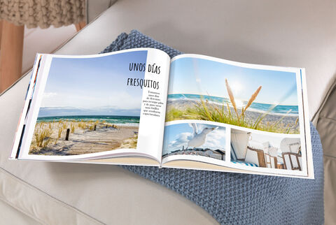 CEWE FOTOBUCH abierto con fotos de vacaciones en la playa y hermosos recuerdos.