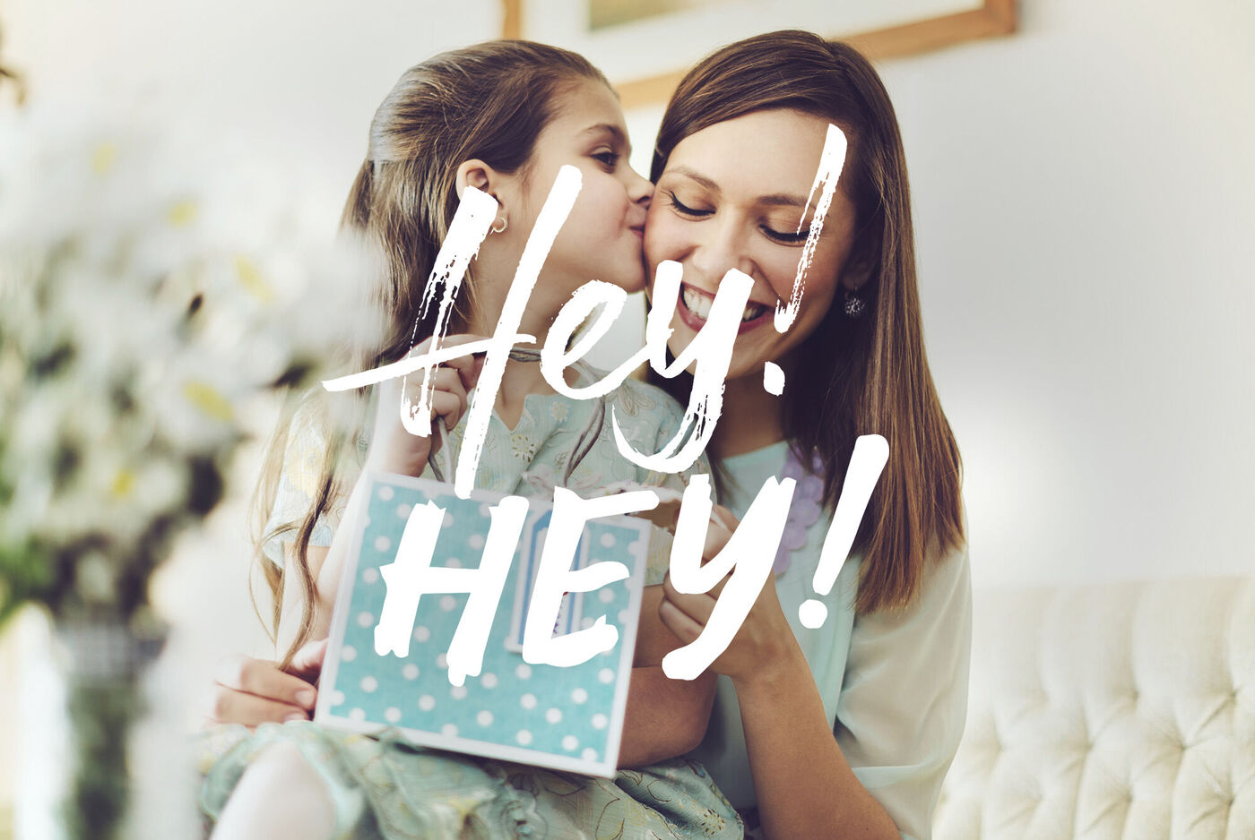 Dos amigas comparten un momento alegre y sonríen. Una sostiene un regalo creativo con puntos.