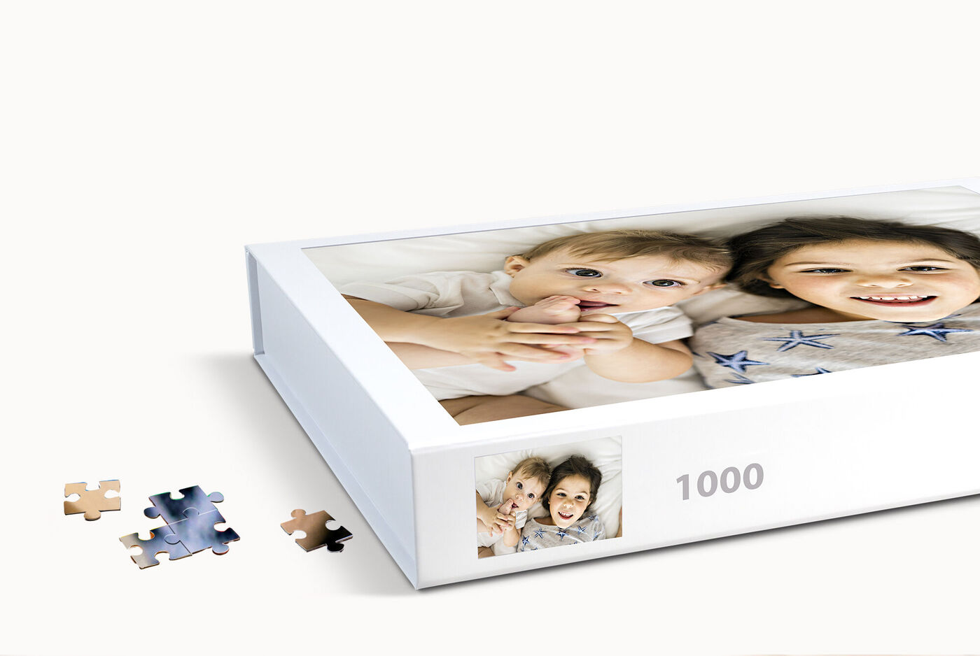 Un rompecabezas CEWE con dos niños en el empaque, máximo 1000 piezas