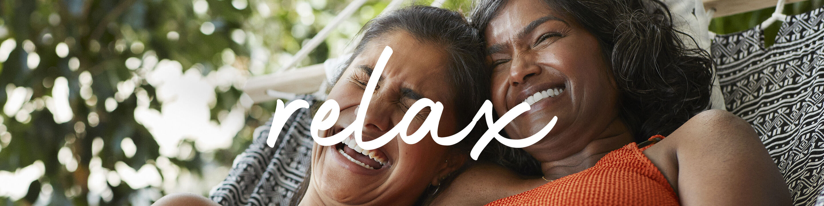 Dos personas disfrutan de un tiempo relajado al aire libre compartiendo bellos momentos en un sillón colgante.