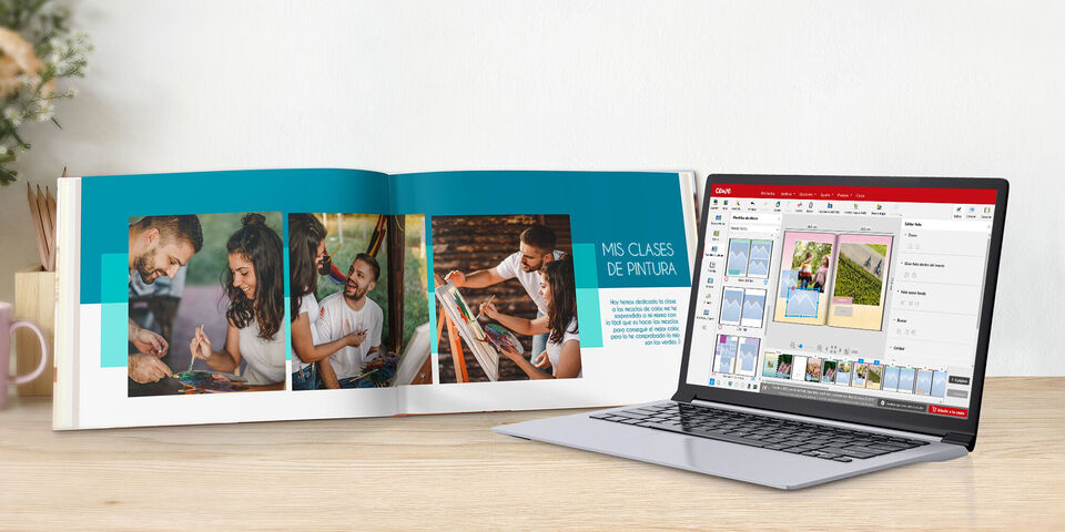 Fotolibro abierto con dibujos para colorear y un portátil que muestra el software de edición.