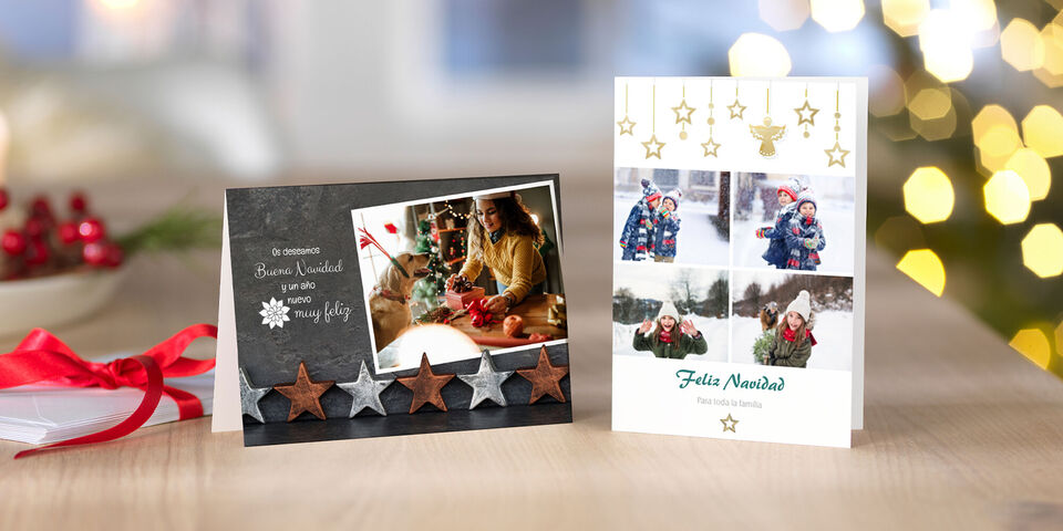 Dos tarjetas festivas sobre una mesa con decoración navideña