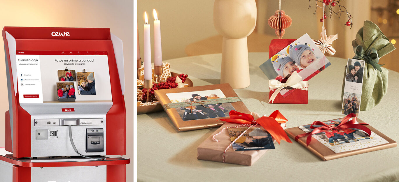 Un quiosco de CEWE que muestra imágenes, en una mesa decorada con regalos.