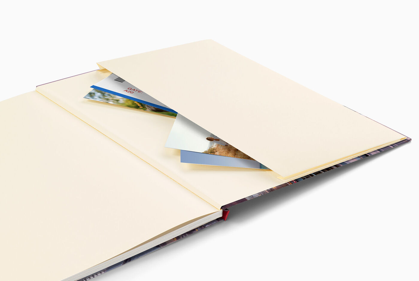 Fotobuch CEWE abierto con páginas beige y fotos insertadas.