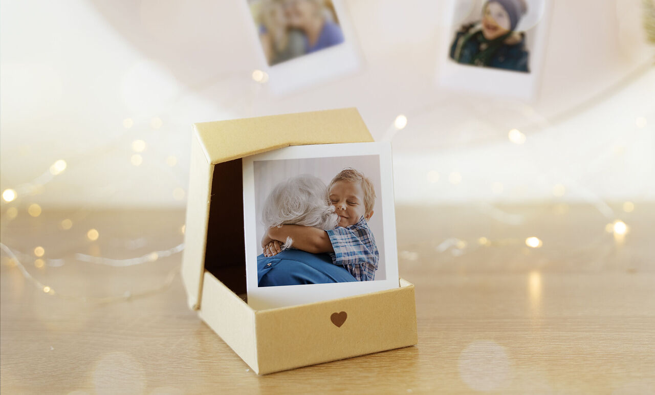 Dos personas se abrazan amorosamente en una mesa con una foto de un momento compartido.